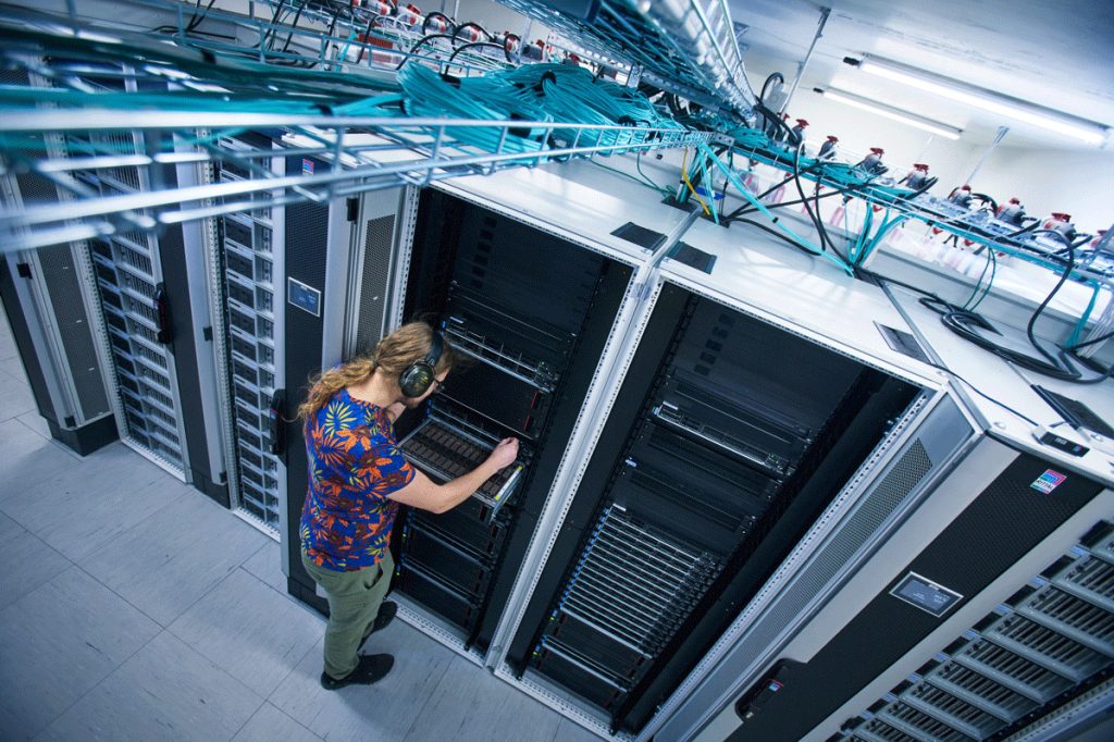 Photo of the Alvis system and technician in server hall