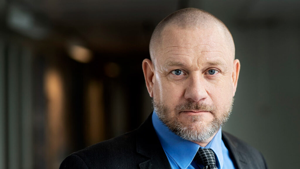 Man with blue shirt and tie