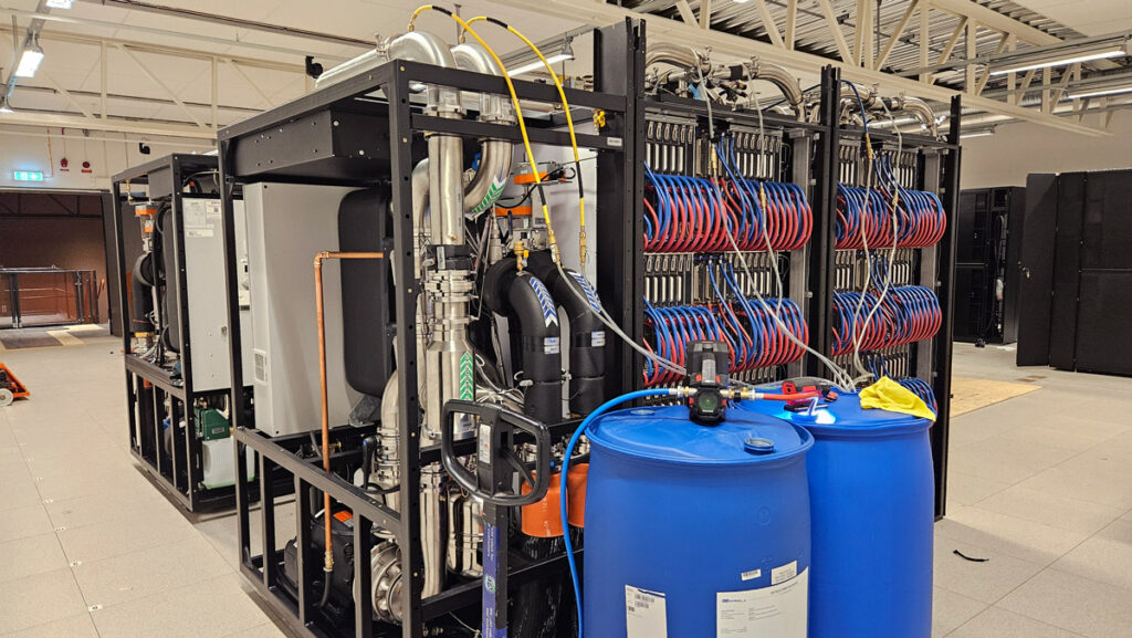 Supercomputer cooling and GPU racks with blue plastic barrels